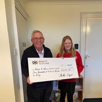Martha Ledger handing over cheque to Chairman Dick McLachlan Martha Ledger