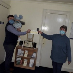 Chris Galloway Jnr presenting Sandra McKinnon with a £200 cheque from his works charity fund, Dunbia UK (Highland Meats). Chris Galloway Jnr