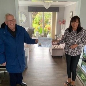 Mrs Grace Sinclair being presented with a certificate of thanks for raising £6279.88 in memory of her late husband Gordon. Mrs Grace Sinclair