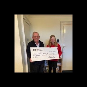 Martha Ledger handing over cheque to Chairman Dick McLachlan Martha Ledger